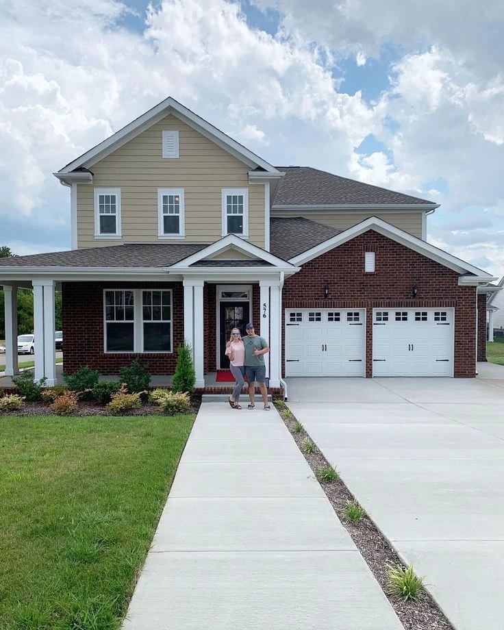 New spring 2026 homebuyers standing happily outside their house and mortgage protection insurance

