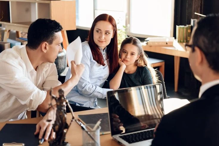 Family discussing financial protection and insurance documents at home table


