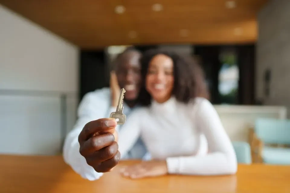 Black homeowner holding house keys representing generational wealth in Maryland