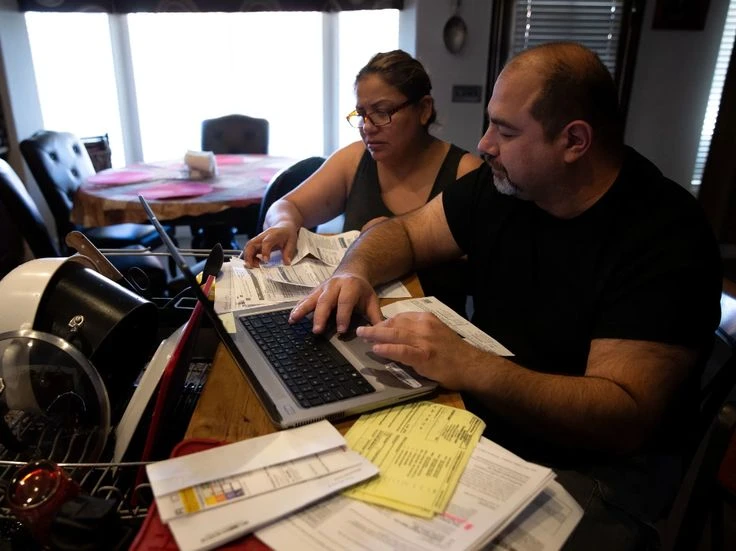How to use Critical Illness Insurance(Avoid Summer Health Scare Emergency) Couple reviewing medical bills at home after a health scare