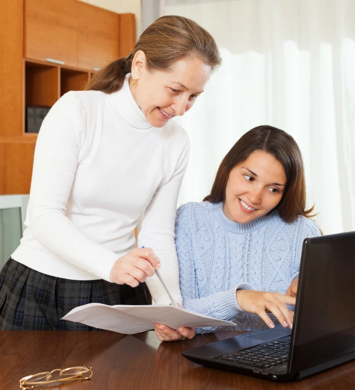 How to Teach Your Kids About Financial Legacy Before They Boldly Leave Home Parent and teenager reviewing financial legacy documents together at home