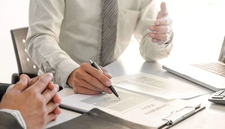 The Ultimate Guide to Index Universal Life as a Will Alternative: What It Can (and Cannot) Protect Person reviewing an indexed universal life insurance policy document