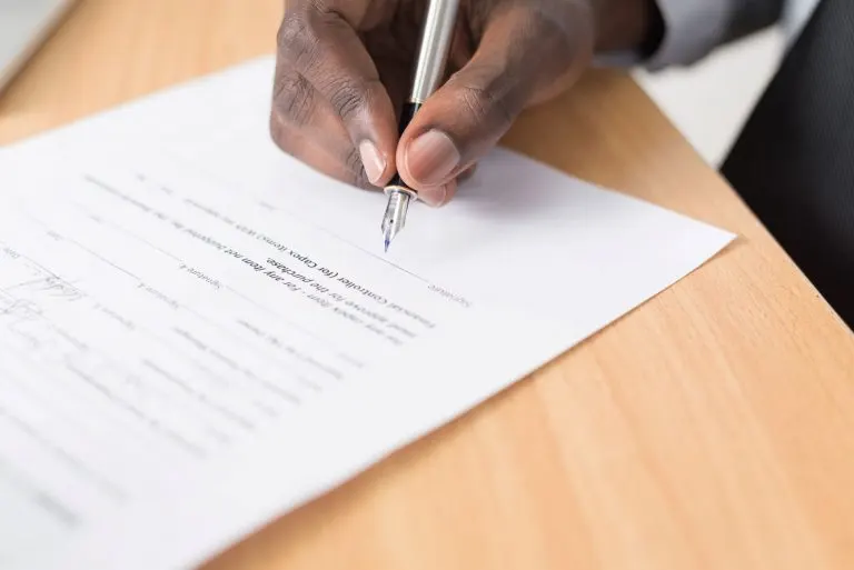 What Dying Without a Will Does to an Estate: The Probate Consequences Most Families Discover Person signing a will at a desk