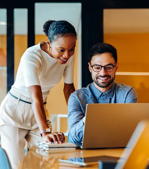 How the Ten Domains of Family Wealth Build True Generational Wealth two adults reviewing documents with a laptop.